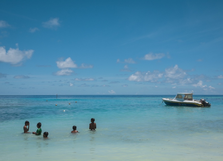 With the northern white sand beach cordoned off for tourists, local Maafushi boys use the waters by the harbour for swimming. 